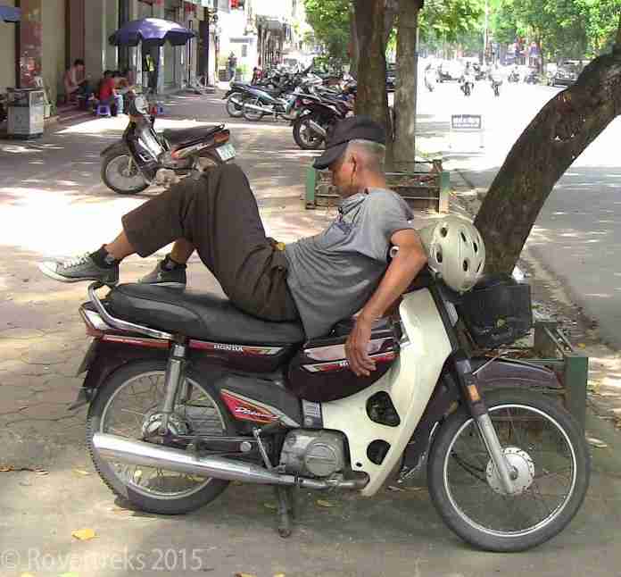 RoverTreks — Man sleeping on motorbike RoverTreks — Man sleeping on motorbike