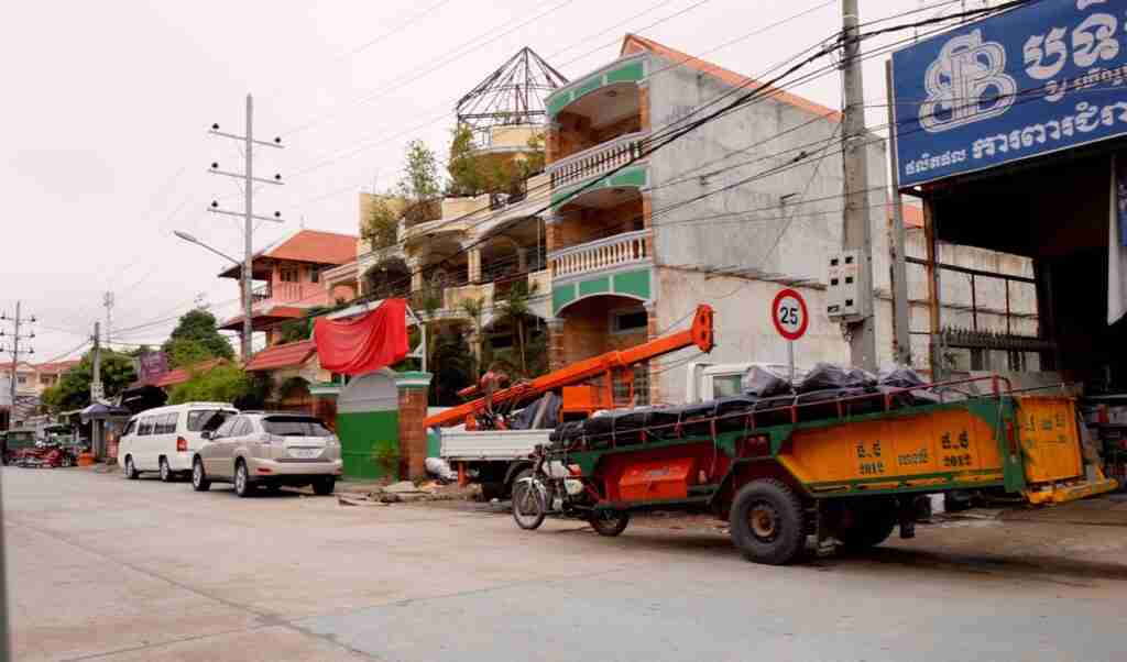 Motorbike pulling ultra heavy trailer, Cambodia