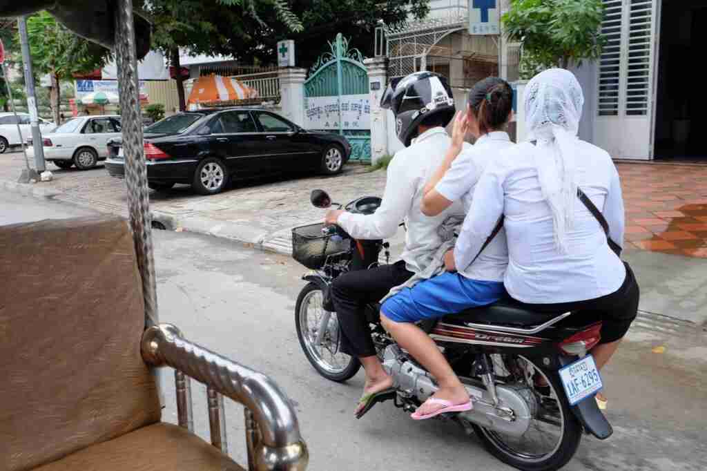 Three on a motorbike, Cambodia — second view